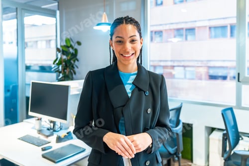 Preview: Smiling young manager posing in modern office