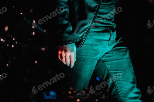 Preview: Closeup shot of male walking in the street with lights