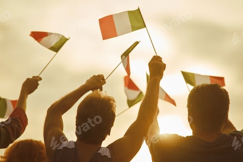 Preview: Young people waving italian flags, back view.