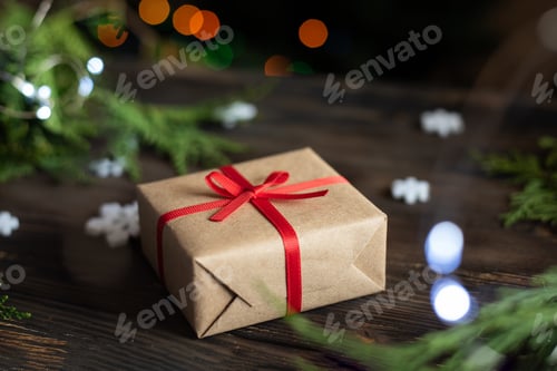 Preview: Wrapped Gift with Red Ribbon and Holiday Decorations