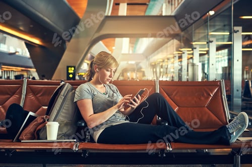 Preview: Social media check done. Shot of a young woman using a cellphone in an airport.