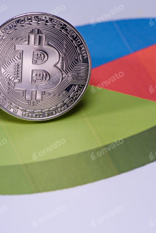 Preview: Close up view of silver bitcoin on colorful diagram