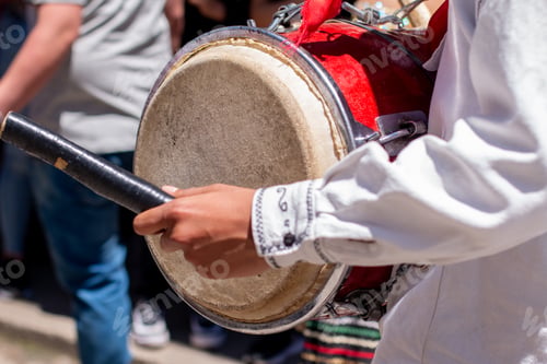 Preview: Close-up of a man playing a bass drum at a Colombian cultural parade.