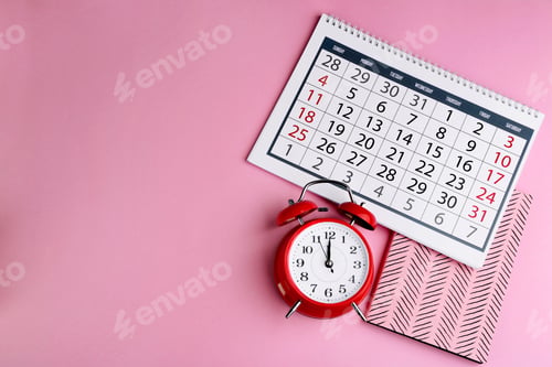 Preview: Calendar, notebook and alarm clock on pink background, flat lay. Space for text