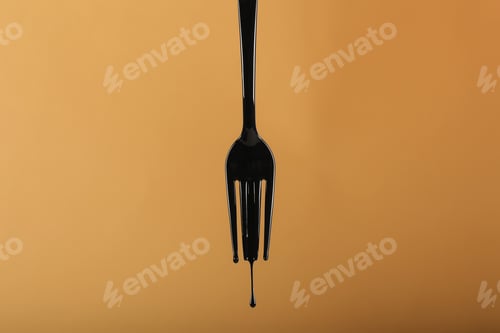 Preview: Plastic Fork In Oil On Yellow Background