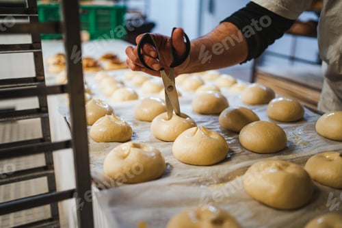 Preview: Baker making cuts in milk buns