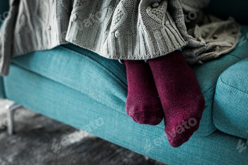 Preview: Closeup pair of legs on the sofa