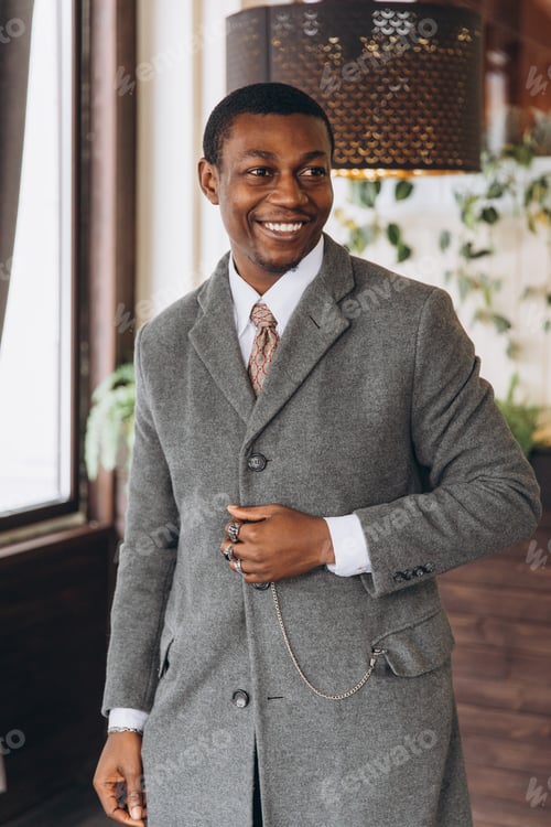 Preview: Stylish African American man wearing grey coat smiling