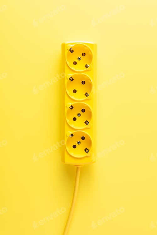Preview: close-up view of bright yellow socket outlet on yellow background