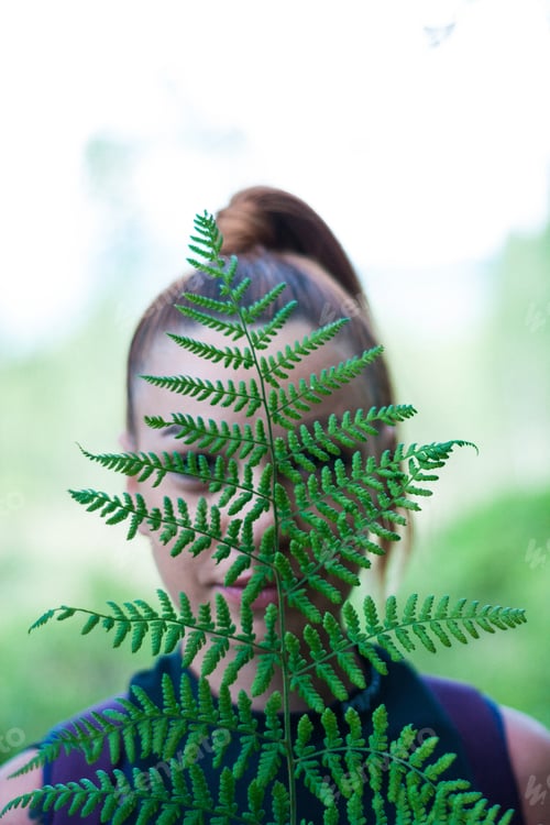 Preview: outdoor portrait of a woman with a fern