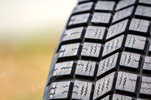 Preview: Close up detail of new black rubber car tire protector, selective focus, on copy space background