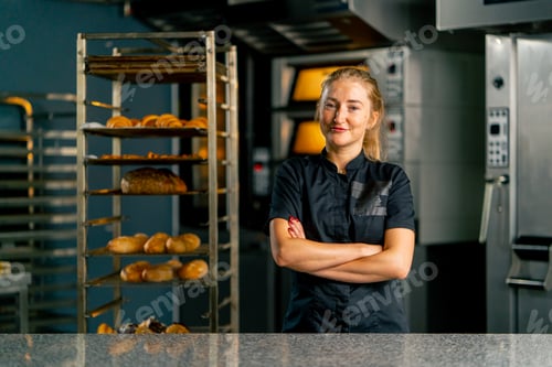Preview: baker in a bakery against the background of ovens and a variety of fresh pastries