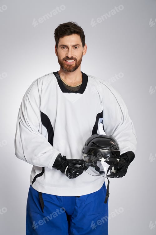 Preview: Happy ice hockey player posing to camera after game.