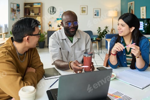 Preview: Multiethnic Adults Collaborating during Informal Office Meeting