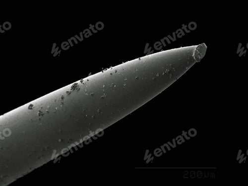 Preview: A closeup view of a sharp pencil tip against a dark backdrop.