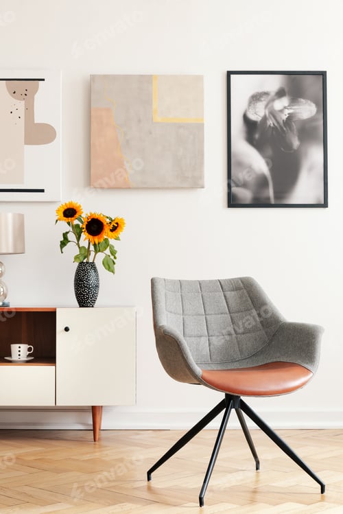Preview: Grey armchair and sunflowers on cabinet in white living room int