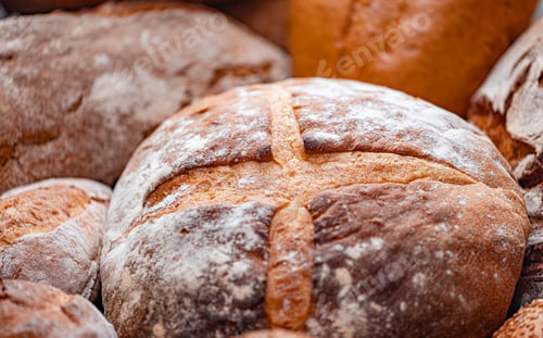 Preview: Freshly baked natural bread is on the kitchen table.