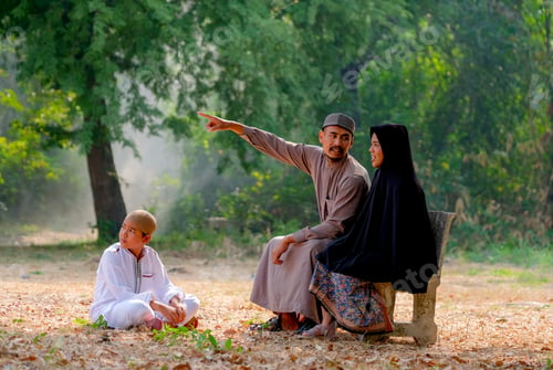 Preview: Muslim man point to some direction and explain to his wife and his son also look at the direction.