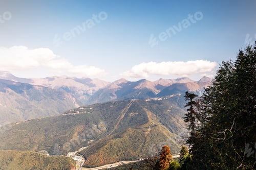 Preview: A high mountain against a background of blue sky and white clouds. Natural backdrop.