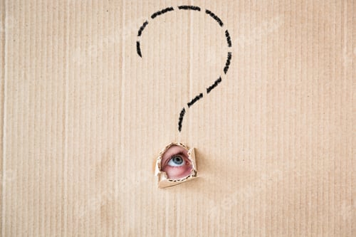 Preview: Surprised person looking through hole of cardboard