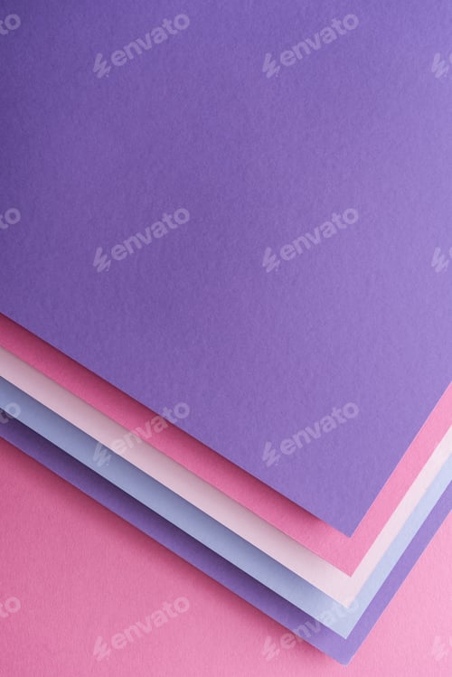 Preview: top view of empty blue, white, pink and purple sheets of paper on pink background