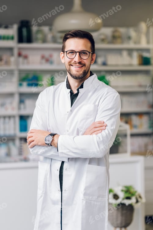Preview: Portrait of a confident pharmacist standing with arms crossed and smiling at the camera.
