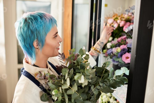 Preview: Blissful florist curating vibrant blooms in a cozy flower shop
