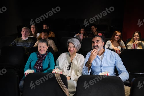 Preview: Group of people watching a movie and eating popcorn in a cinema