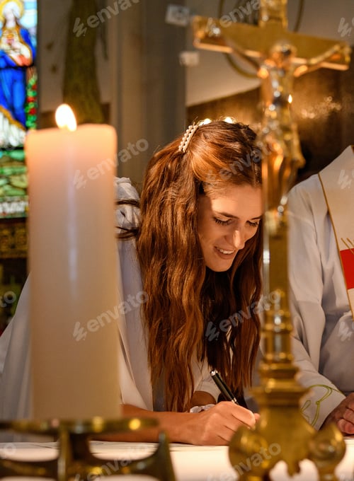Preview: Beautiful bride signing marriage certificate in catholic church.