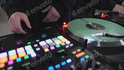 Preview: DJ spinning record at disco. Art. Close-up of DJ's hand on mixer. Glowing music panel at party