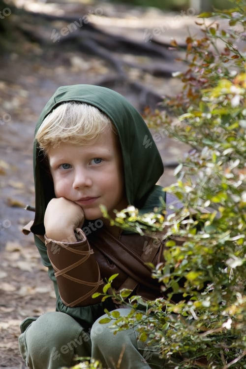 Preview: Close up portrait of a boy in a medieval costume against a forest background