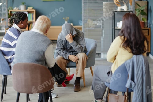 Preview: Diverse Group Supporting Distressed Teenager Sitting in Therapy Session