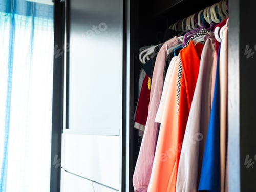 Preview: Clothes in wardrobe close up, choice clothing store interior room home.