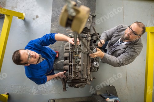 Preview: Two mechanics working on a machine part
