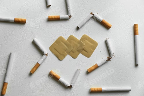 Preview: Nicotine patches and broken cigarettes on white background, flat lay