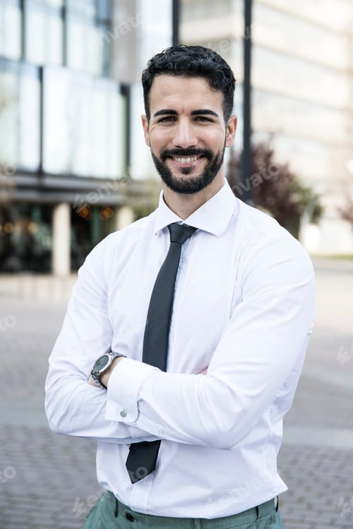 Preview: Good-looking businessman looking at camera with arms crossed. Confident and smiley executive