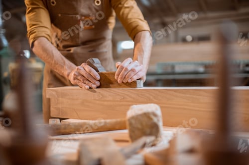 Preview: Carpenter working with a wood in the workshop