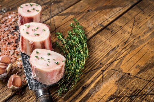Preview: Beef Marrow bones, raw meat with herbs. Wooden background. Top view. Copy space