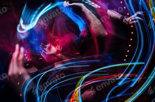 Preview: Closeup view of the colorful blurred lights with the motion of people dancing in the club