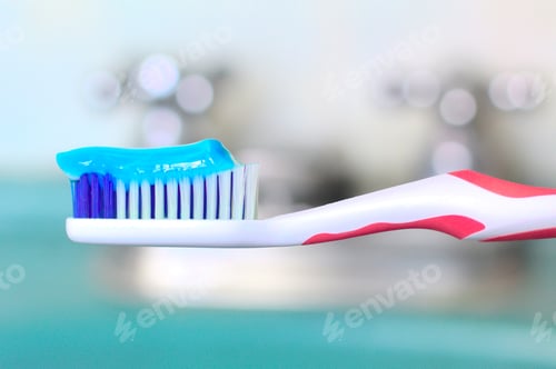 Preview: Closeup shot of a toothbrush with a strip of blue toothpaste