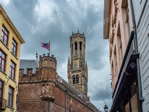 Preview: Low angle shot of Bruges flag with Belfort tower background