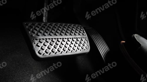 Preview: Man foot and accelerator and brake pedal inside the car