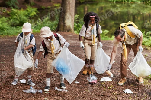 Preview: Group of scouts picking up trash in forest during eco awareness field trip