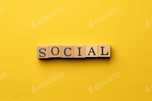 Preview: a yellow warm background without shadows wooden cubes with black letters laid out word social