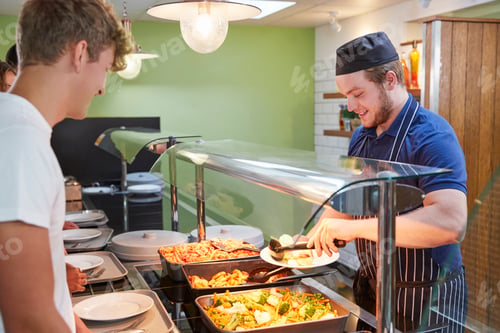 Preview: Teenage Students Being Served Meal In School Canteen