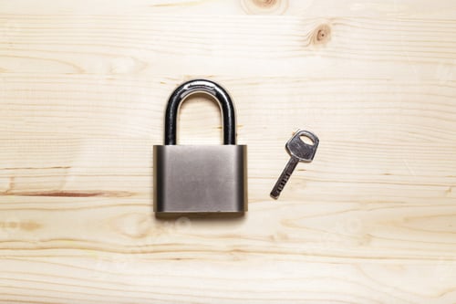 Preview: check-lock on the wooden table background
