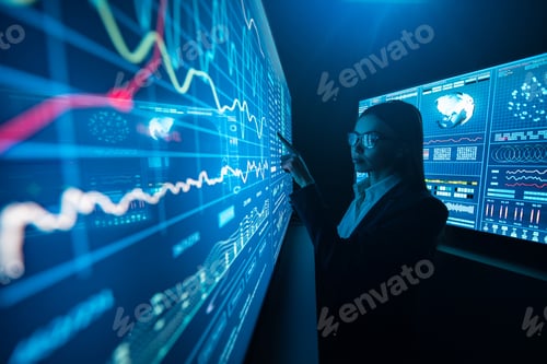 Preview: The business lady standing near the sensor screen in the dark laboratory.