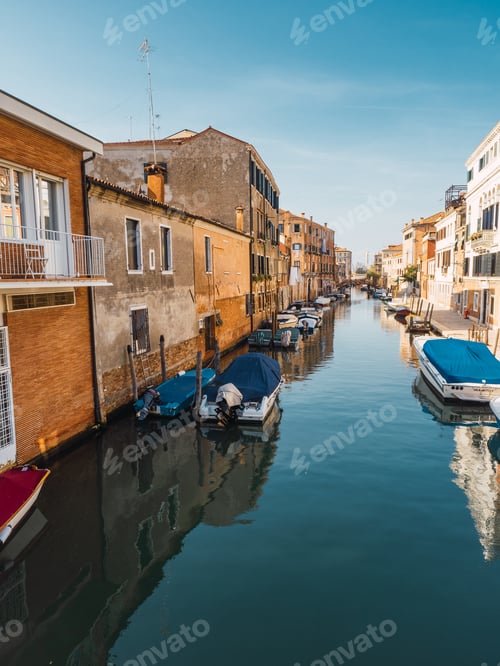 Preview: Houses and boats along a water canal in Venice.