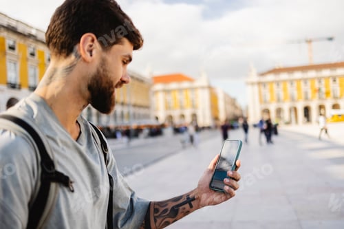 Preview: Tourist using smartphone app for visiting lisbon, portugal