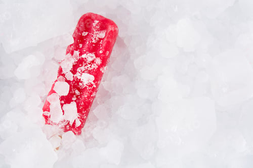 Preview: Strawberry popsicles on ice cubes. Top view.